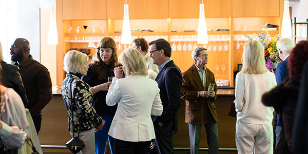 Curator Alison Hearst and members enjoying cocktails