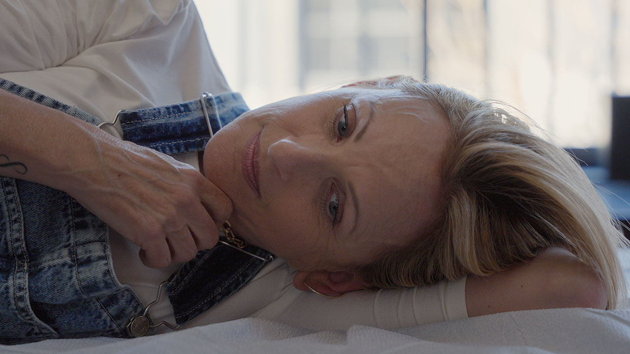 Blonde woman laying on bed