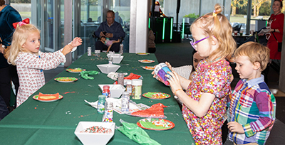 three children decorating cookies
