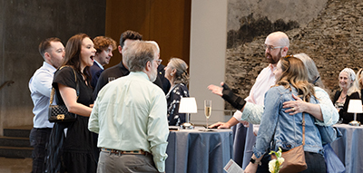 Guests standing at a table talking