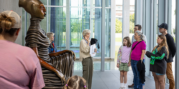 Families and docent in front of Wangechi Mutu sculpture