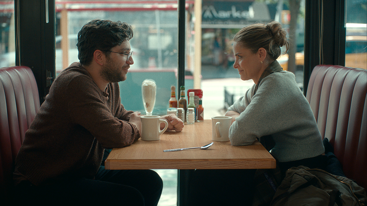 Man and woman facing each other in restaurant booth