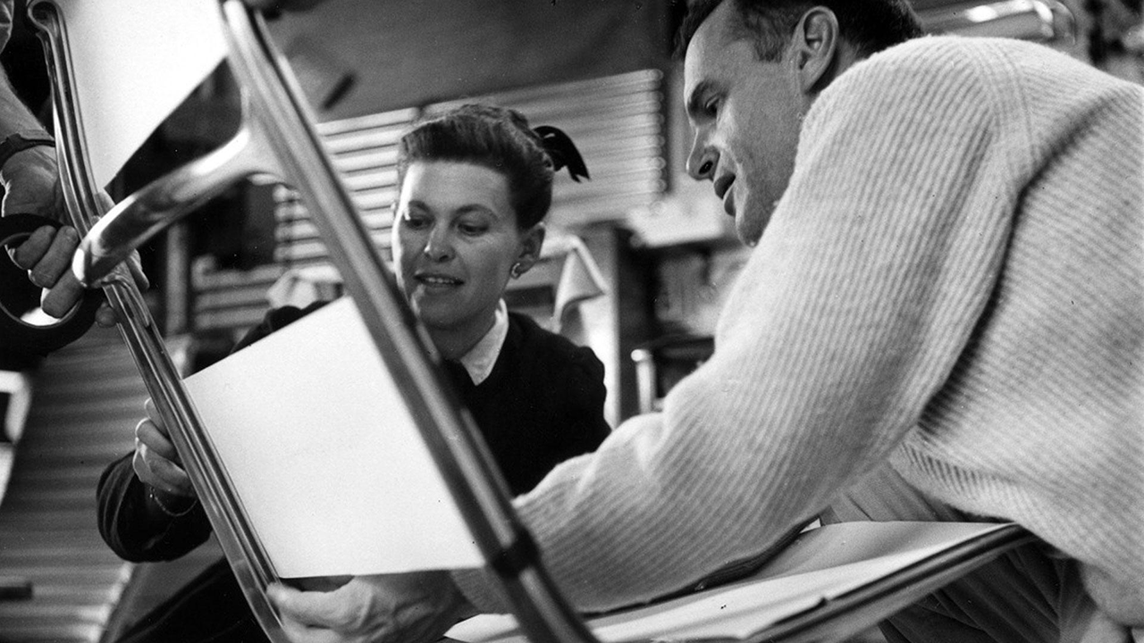 Charles and Ray Eames working on furniture