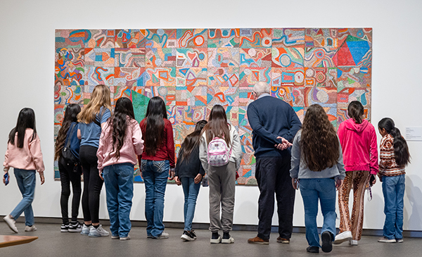 Young people looking at an artwork