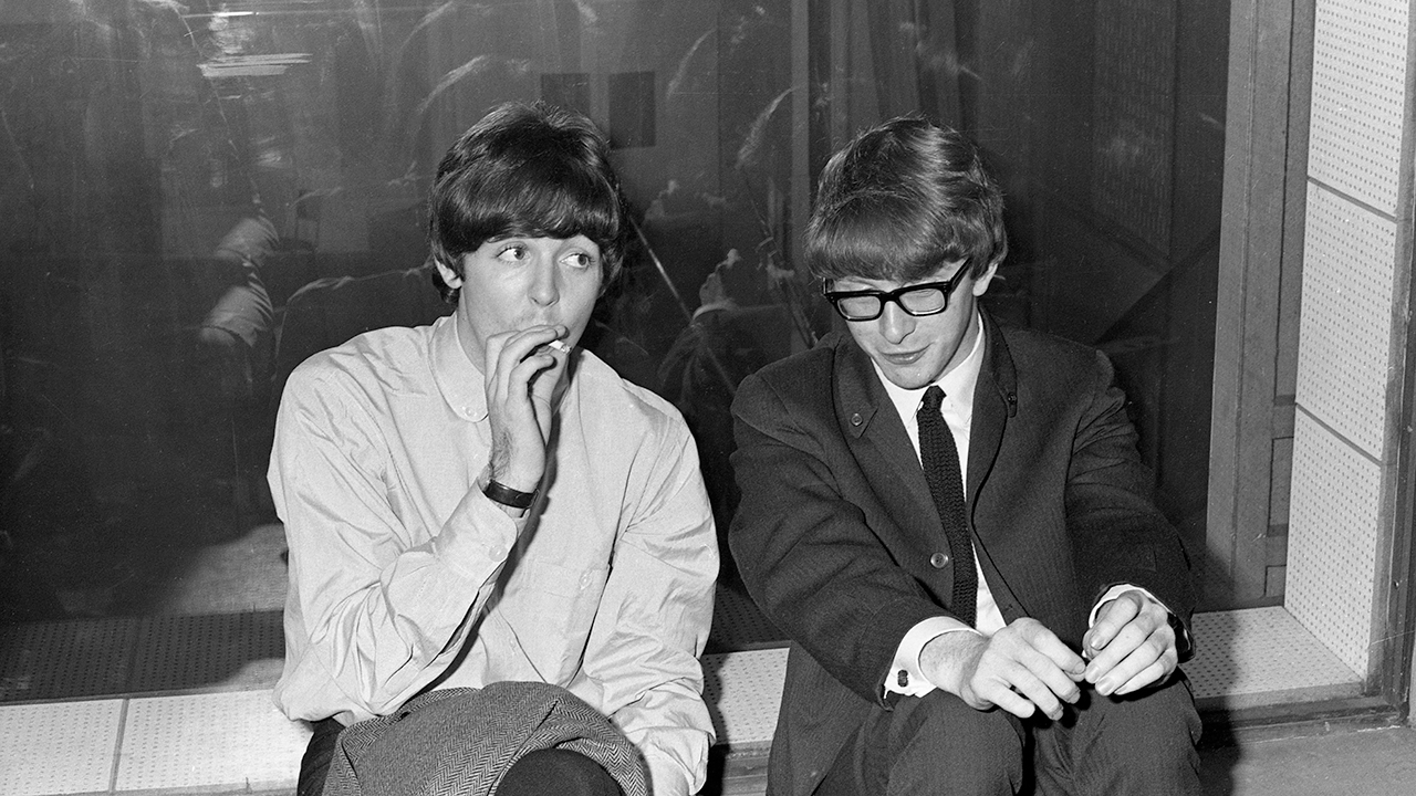 Guitarist and singer Peter Asher sitting by Paul McCartney
