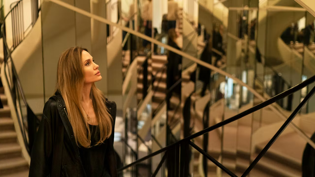 Middle-aged woman standing in mirrored staircase