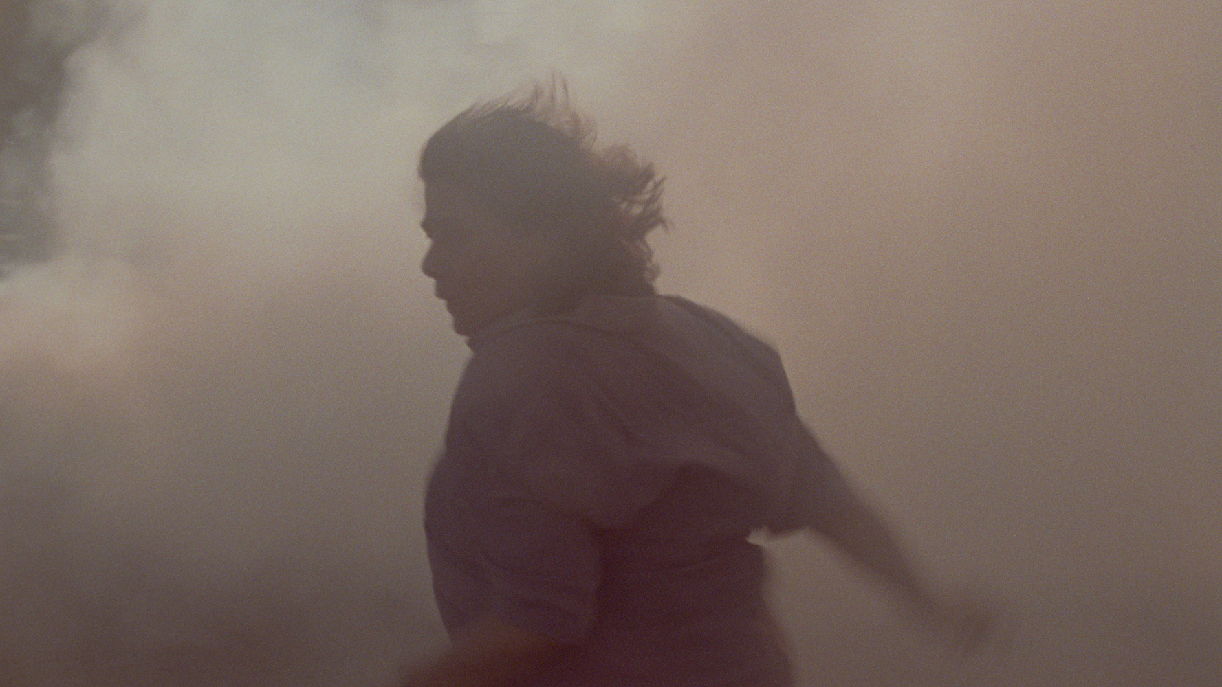 Person running through smoke