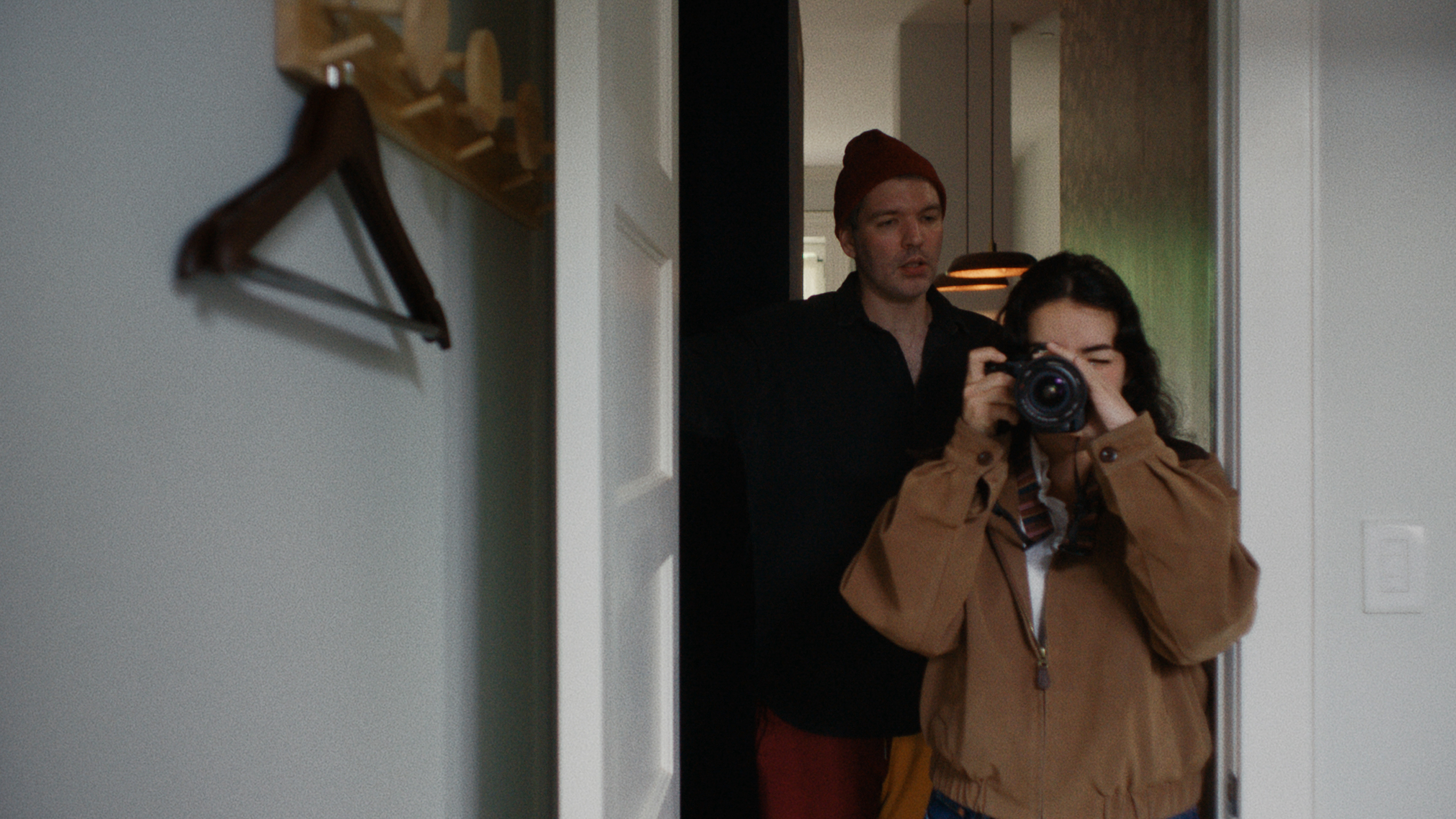 Young white woman photographing small NYC apartment