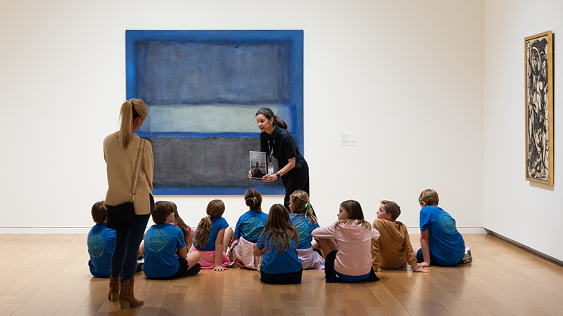 Tour group in front of Abstract blue painting by Mark Rothko