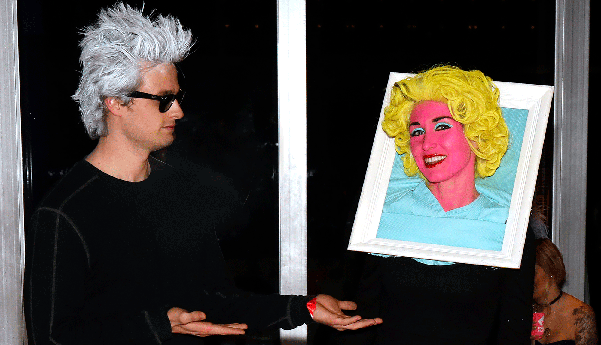 Man and woman dresssed up like Warhol and Marilyn Monroe