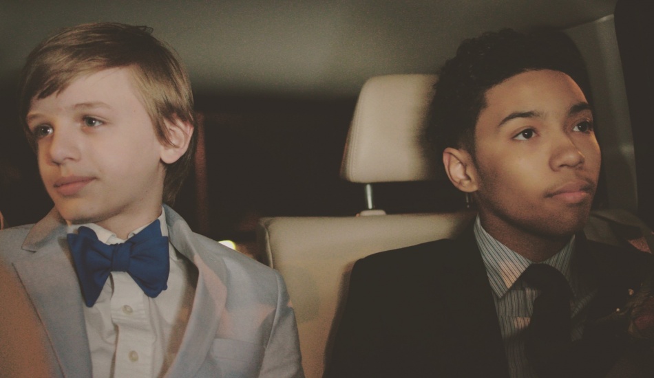 two_boys_in_suits_in_back_seat_of_car