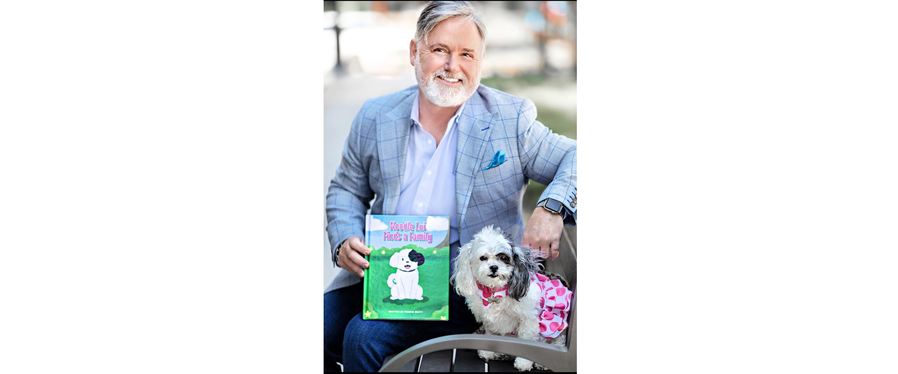 Author Ronnie Beatty and dog Noodle Lui pose with book