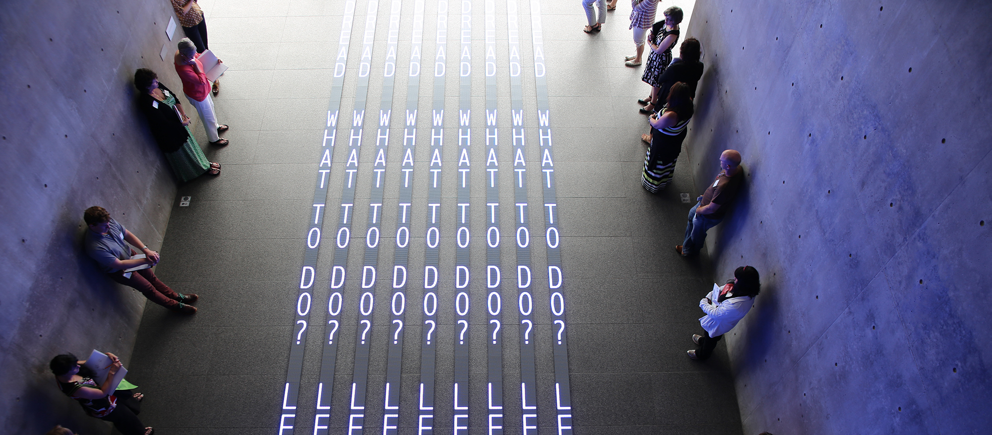 People in gallery with jenny Holzer's Kind of Blue