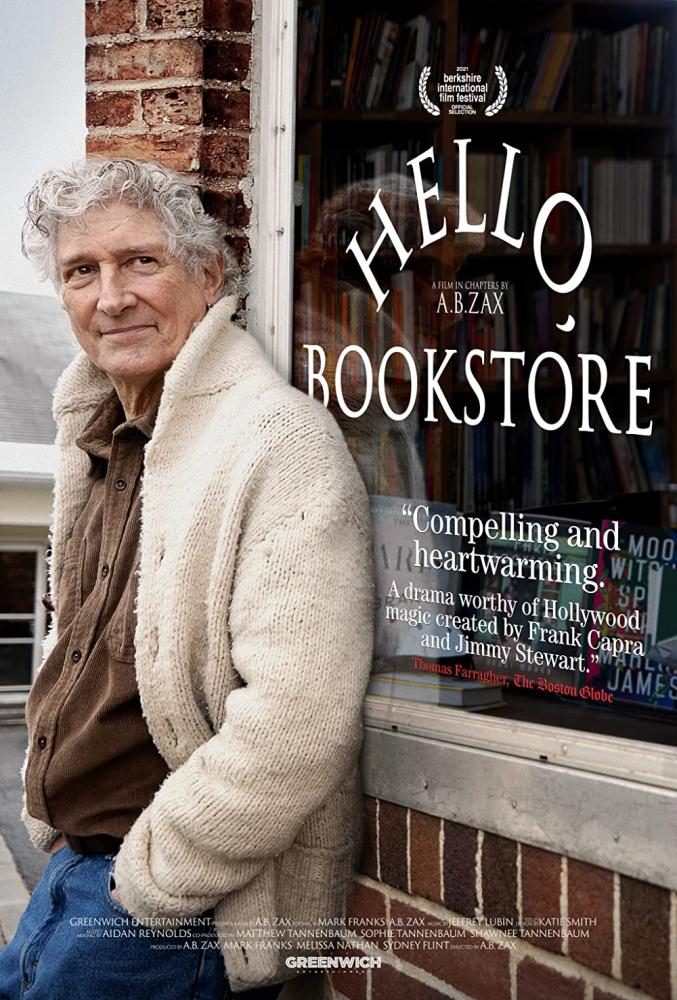 man_leaning_against_bookstore_window