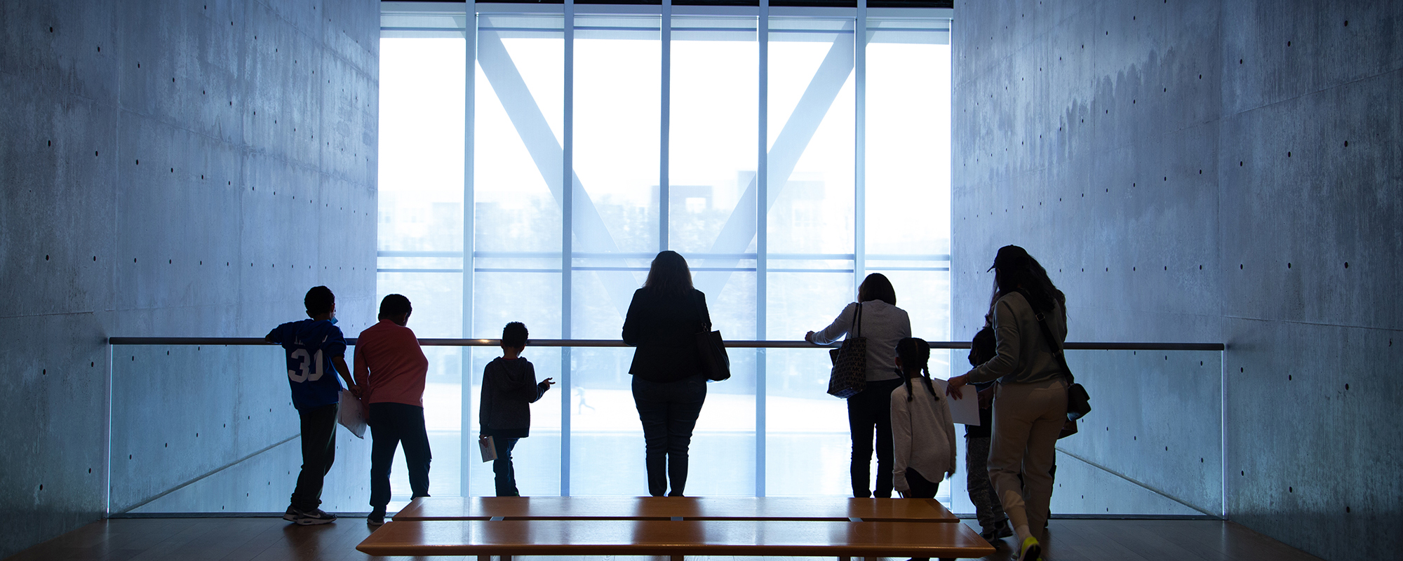 Families looking out museum window
